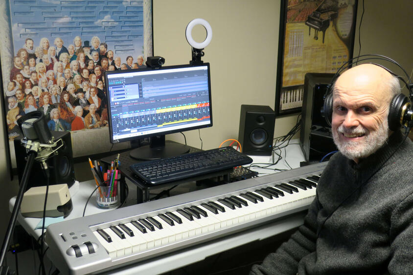 Stephen Demers, composer, in home studio with keyboard and recording equipment
